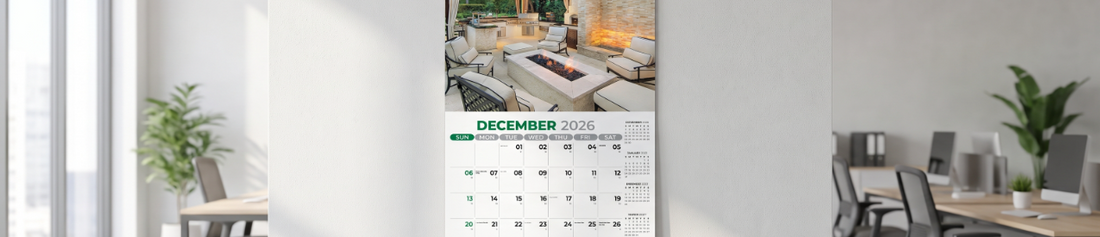 A 13-month calendar on the December page hanging on an office space wall.