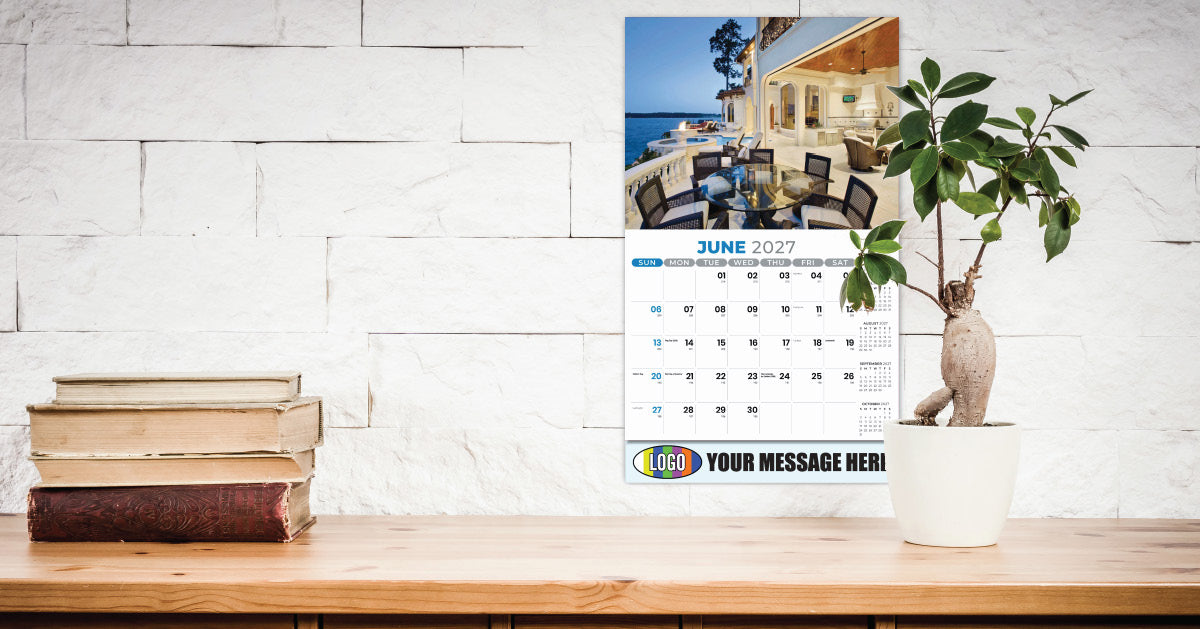 Promotional Calendar on a desk with books and a plant, against a white brick wall.