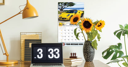 Decorative setup with a car calendar, sunflowers, and a digital clock on a desk.