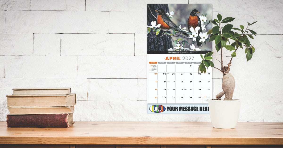 Business Promotional Calendar on a wooden surface with books and a plant, against a white brick wall.