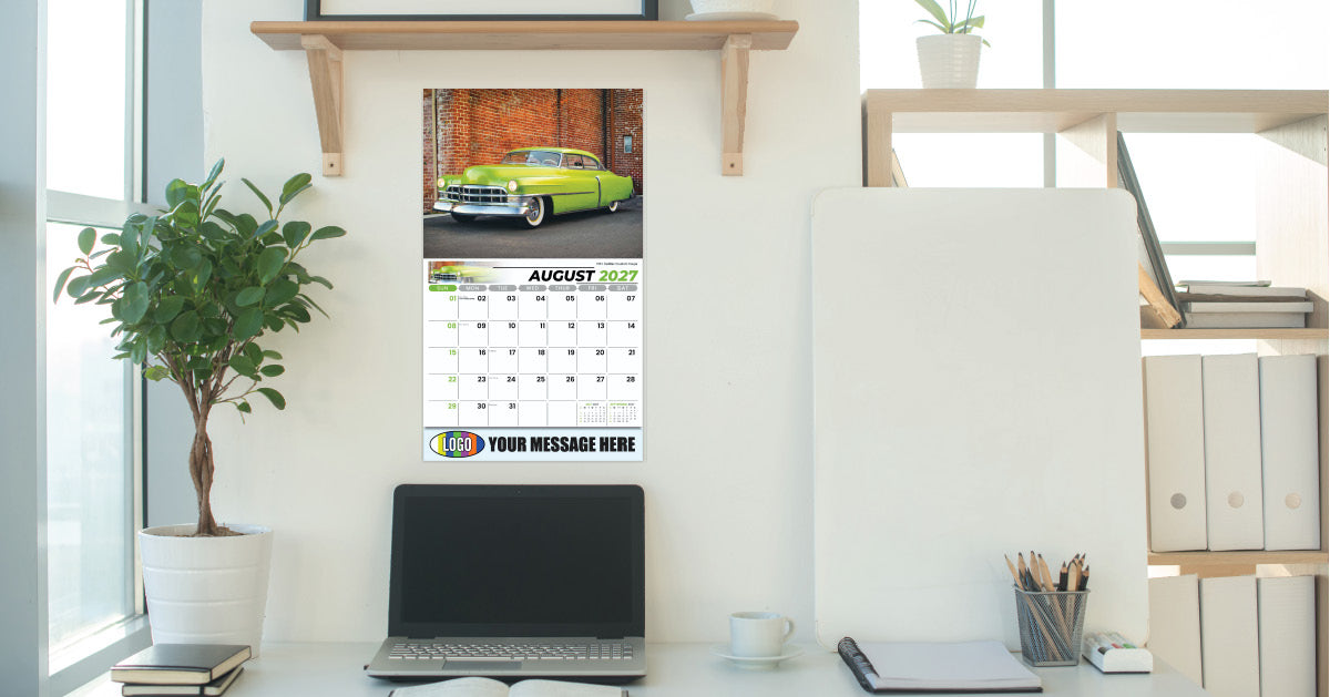 Vintage Car Calendar on a desk with a laptop and office supplies, featuring a green car image.